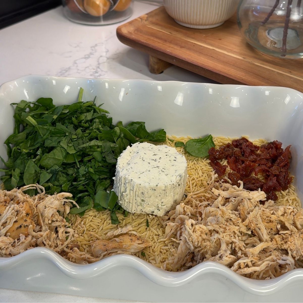 one pan casserole dish with spinach, boursin cheese, sun dried tomatoes, rotisserie chicken and orzo rice