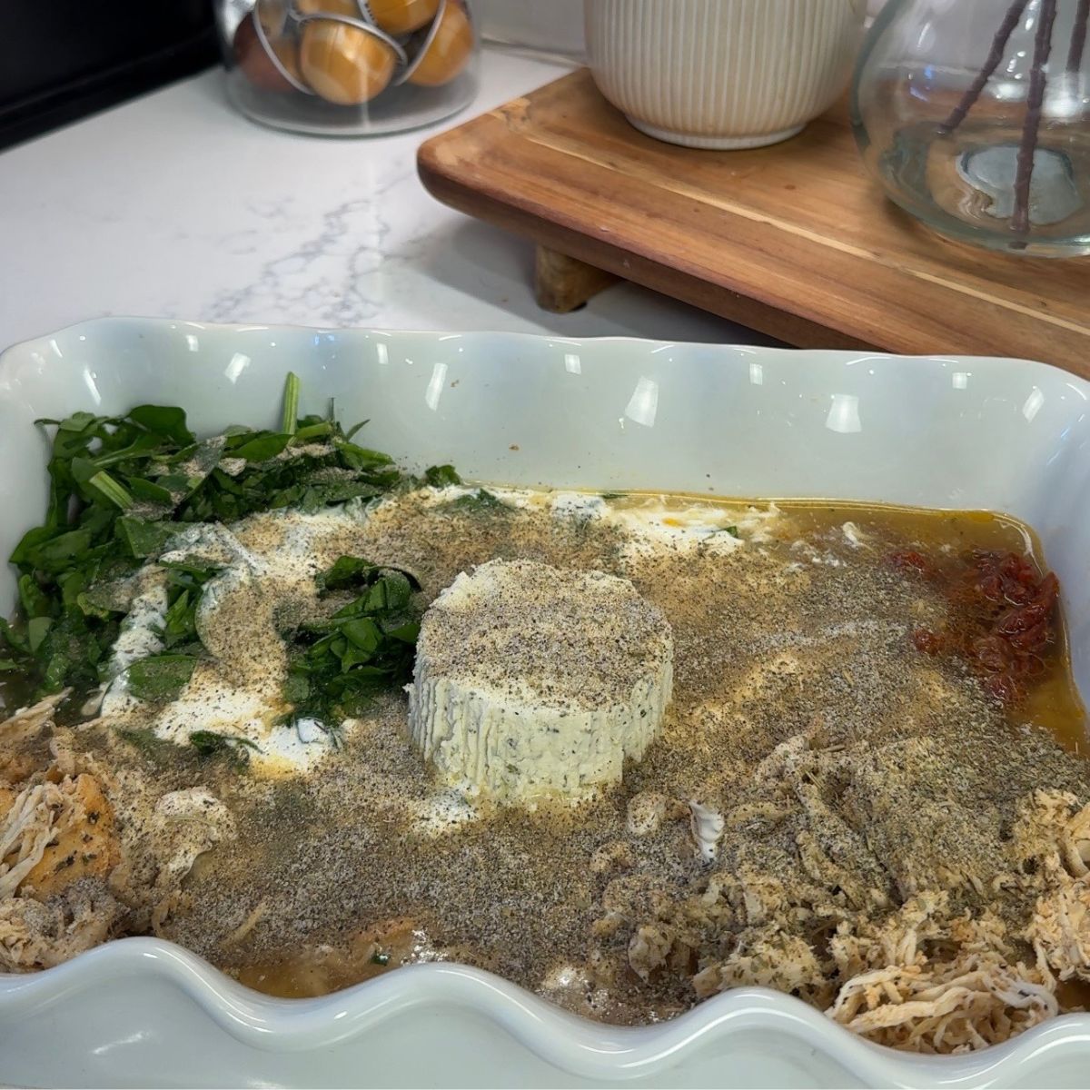 marry me chicken ingredients in casserole dish with seasonings added