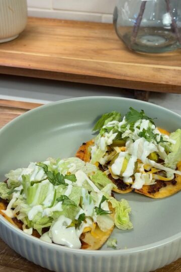 bbq ranch smashed chicken tacos on green plate