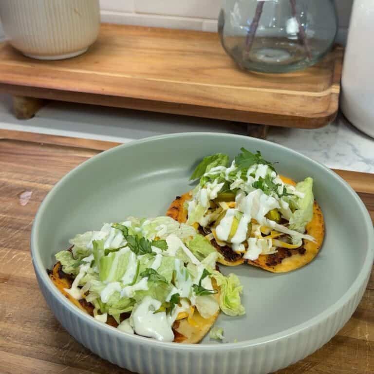bbq ranch smashed chicken tacos on green plate