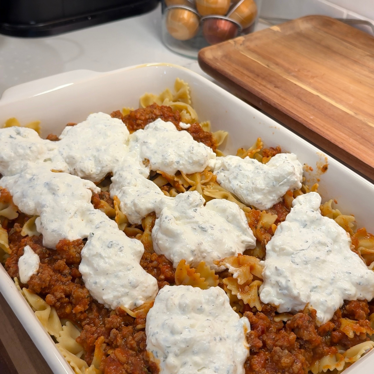 bakeware pan with cooked pasta, meat sauce and cheese 