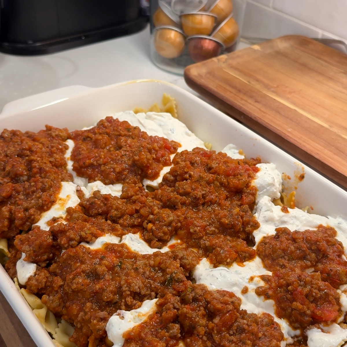 million dollar pasta casserole with pasta noodles, meat sauce, cheese mixture and additional layer of meat sauce