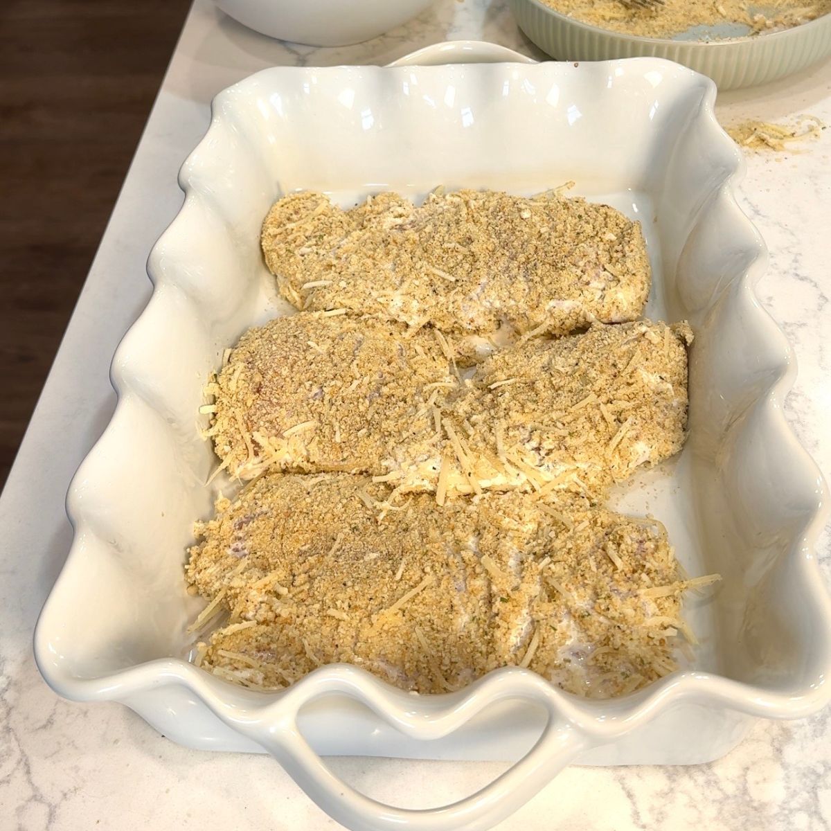 breaded chicken breast in casserole dish