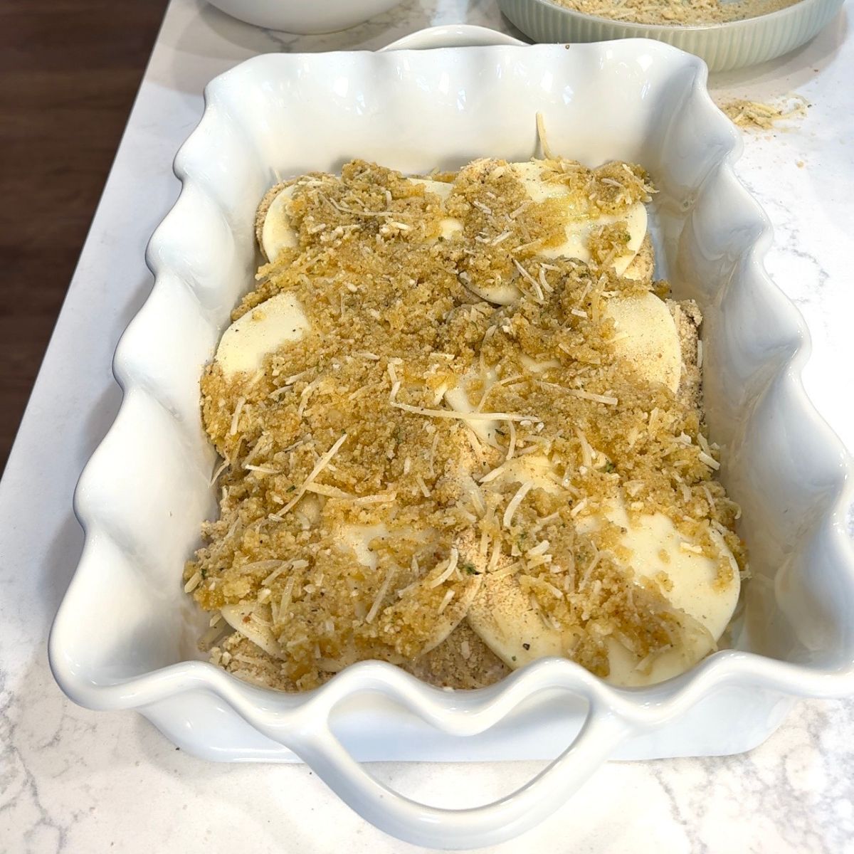 breading spread on top of cheese and chicken 
