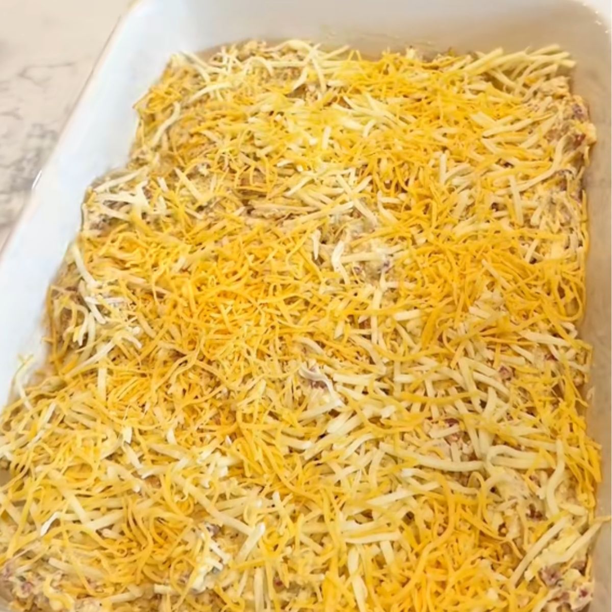 casserole with chicken mixture and cheese on top