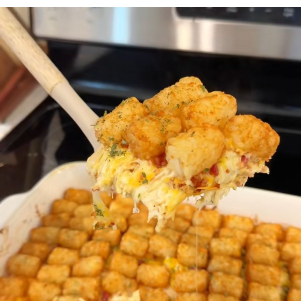 easy dinner idea tater tot casserole being held on spatula