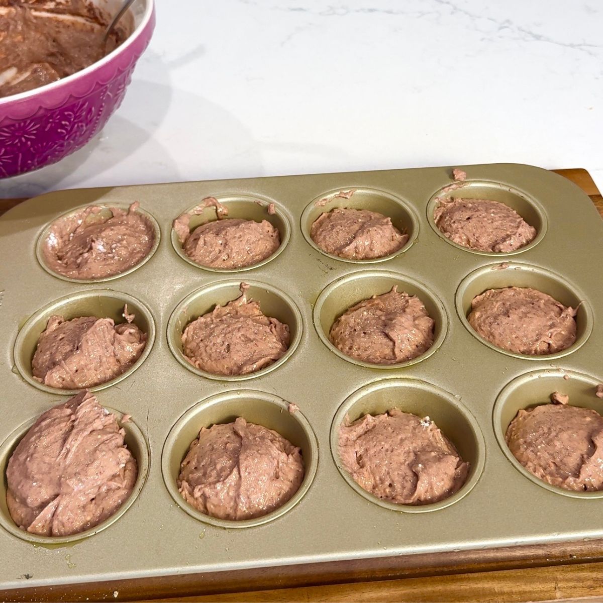 chocolate  muffins in gold muffin tin precooked