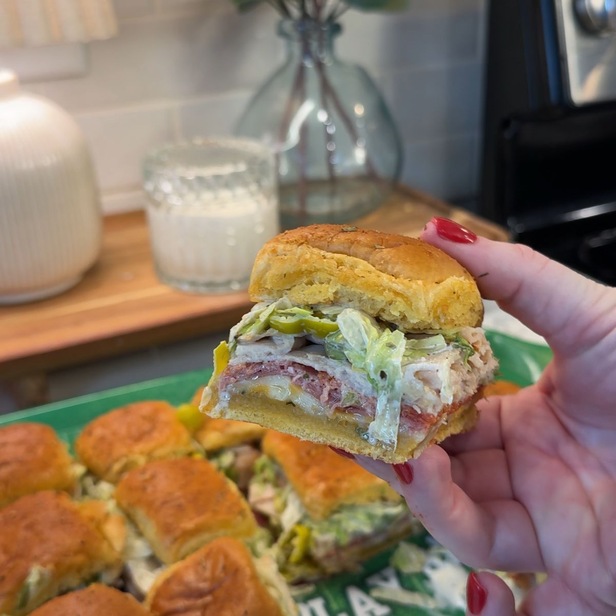 easy italian mini sandwiches sliders with one being held in hand with red nail polish