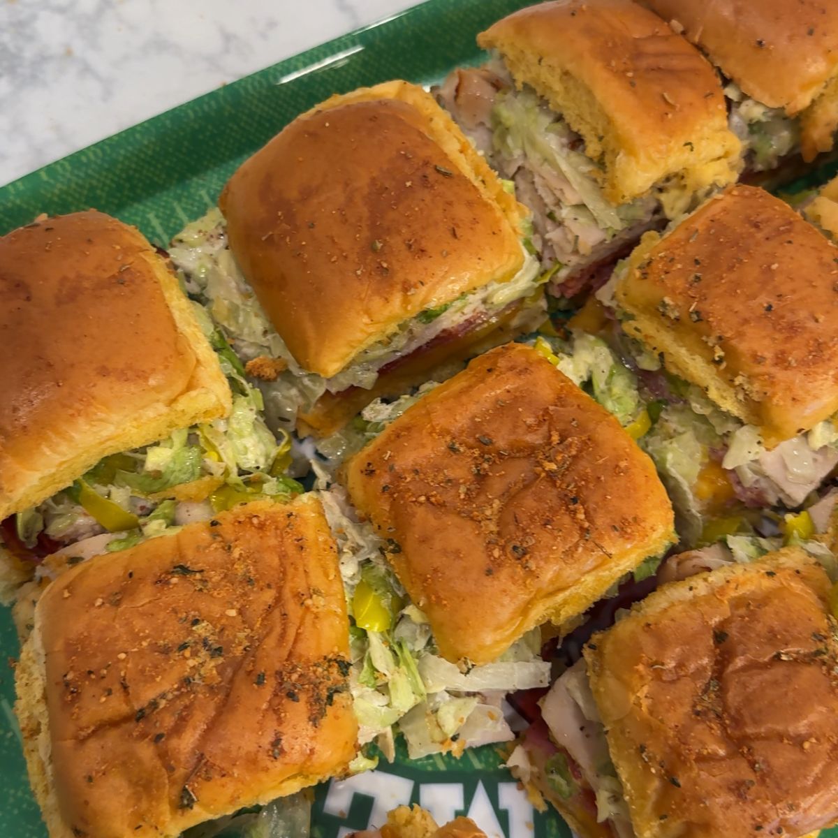 italian grinder sliders on green tray