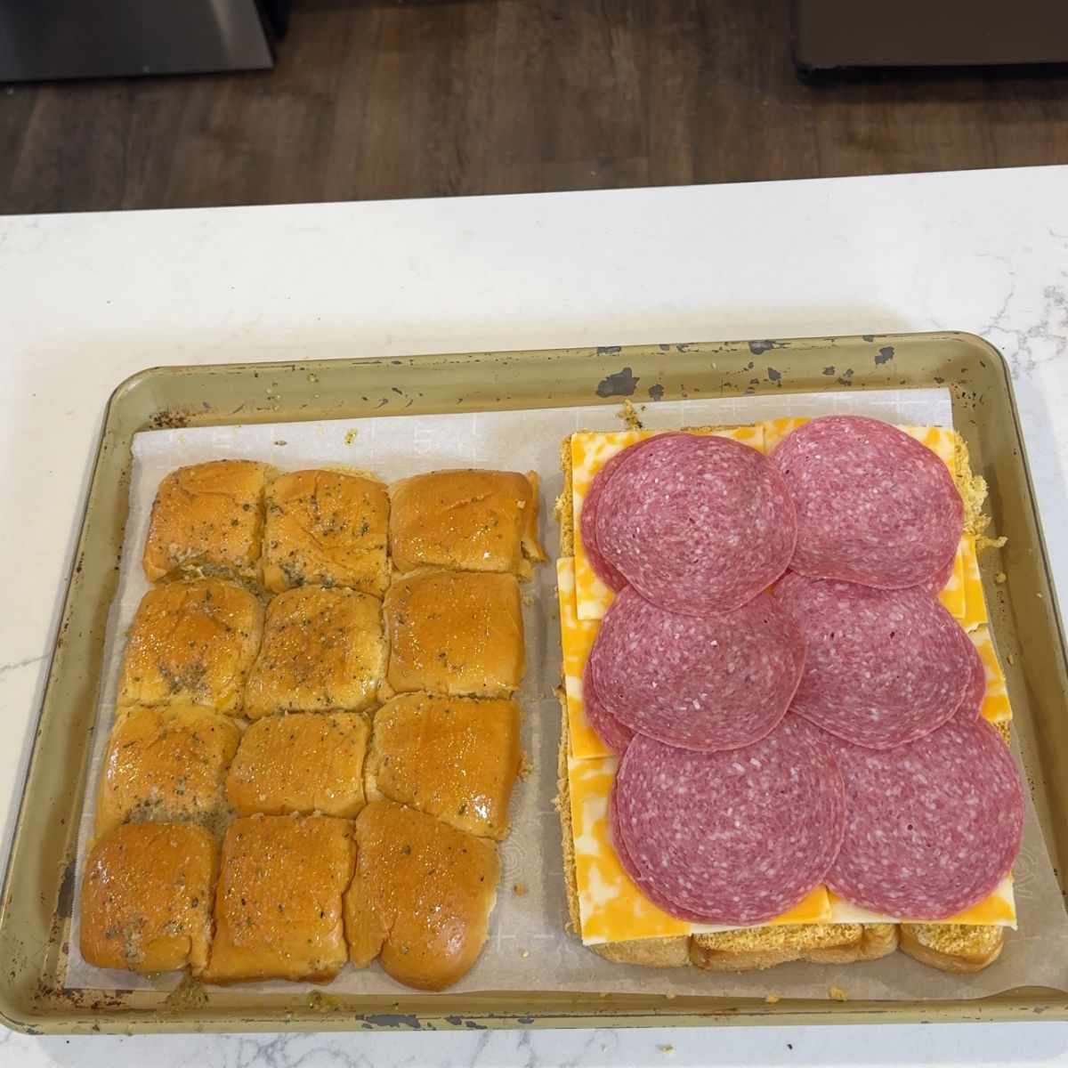 sliced mini sub rolls with cheese and layer of salami