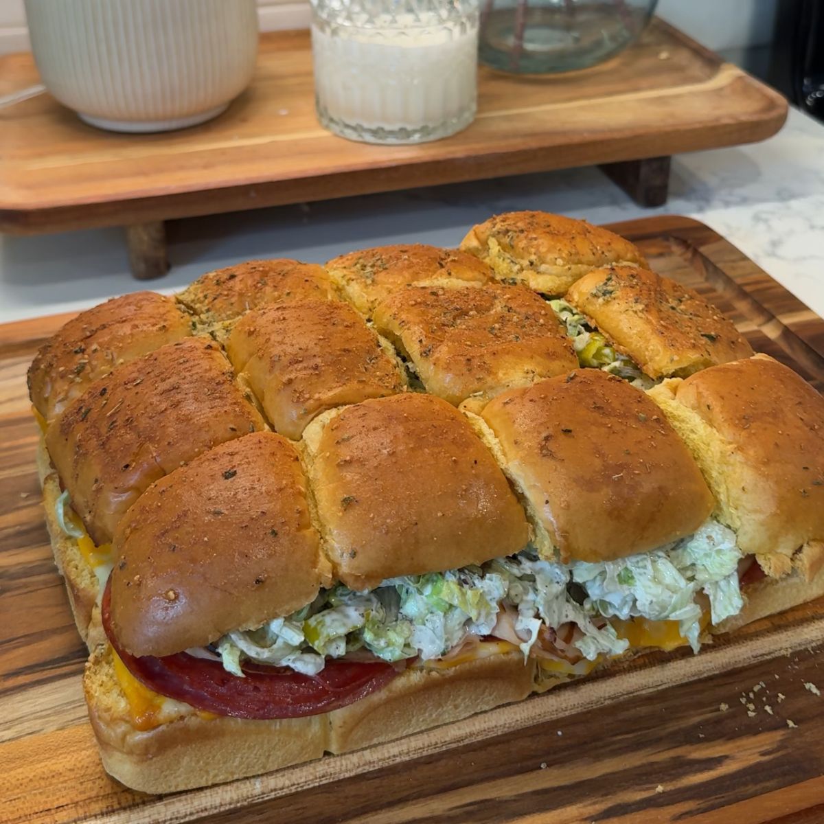 italian grinder sliders on wooden cutting board