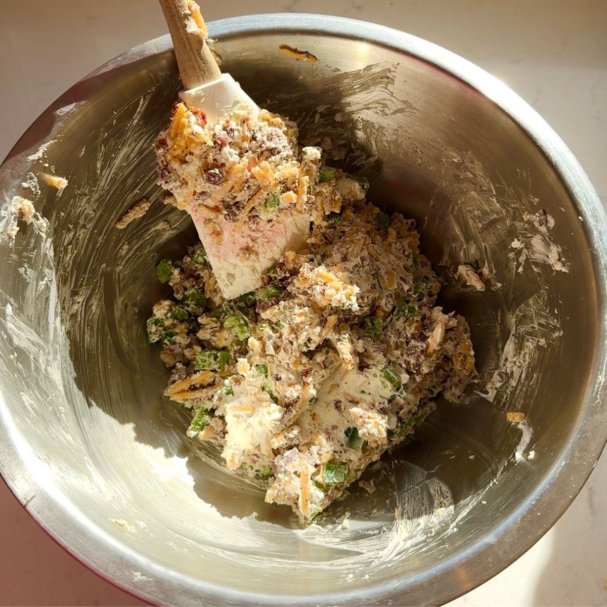 recipe ingredients mixed together with spatula in bowl