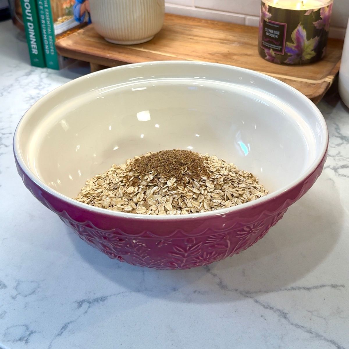 oats and flaxseed in pink ceramic mixing bowl