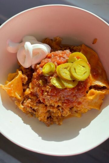 beef & rice enchilada skillet in bowl with jalapenos and sour cream