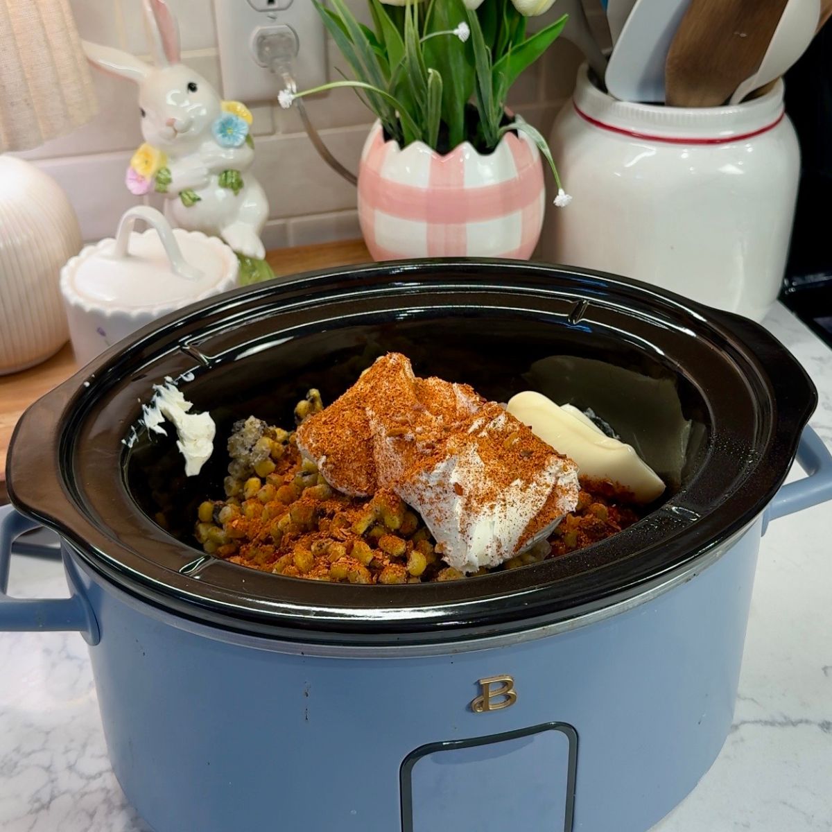 taco seasoning, cream cheese, corn, salsa and chicken in pot