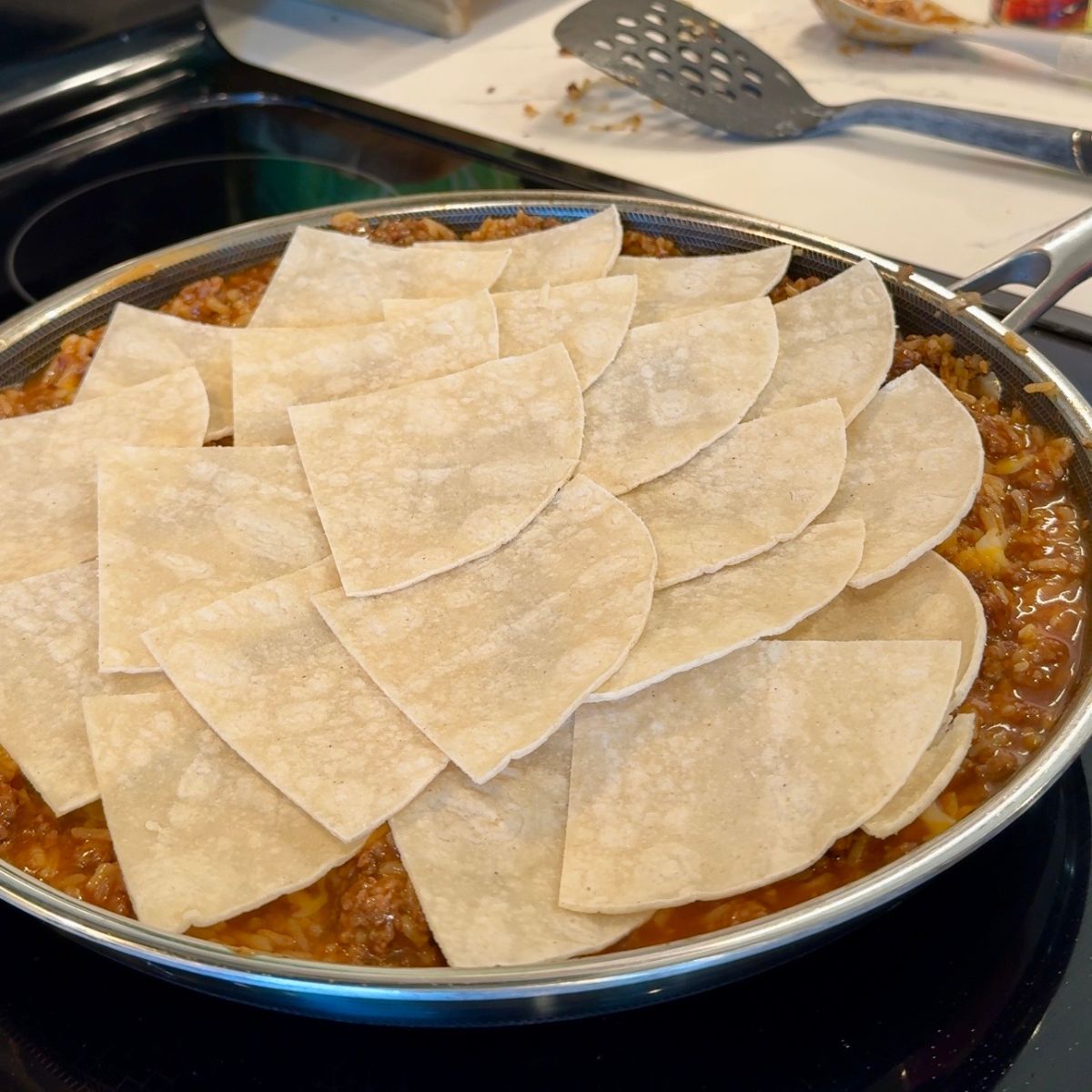 white tortillas placed on top of mixture