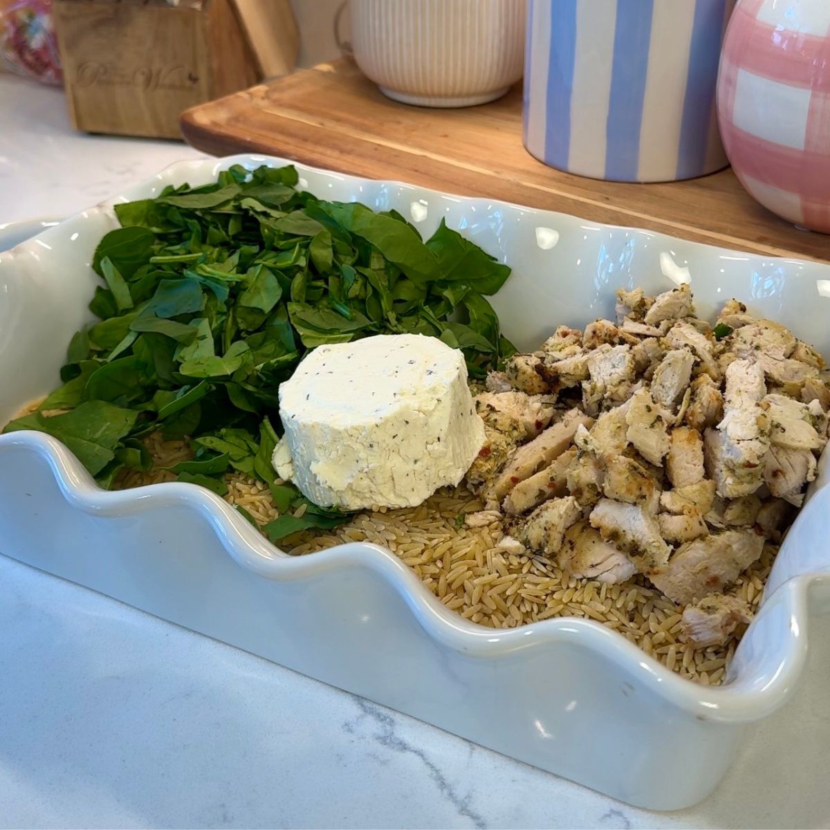 chicken, spinach cheese and orzo in casserole dish