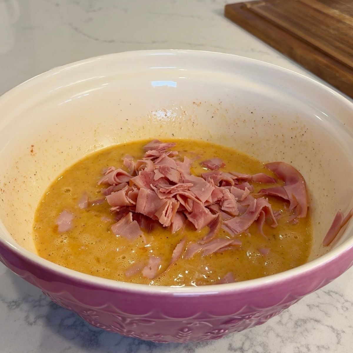 sliced ham in egg mixture