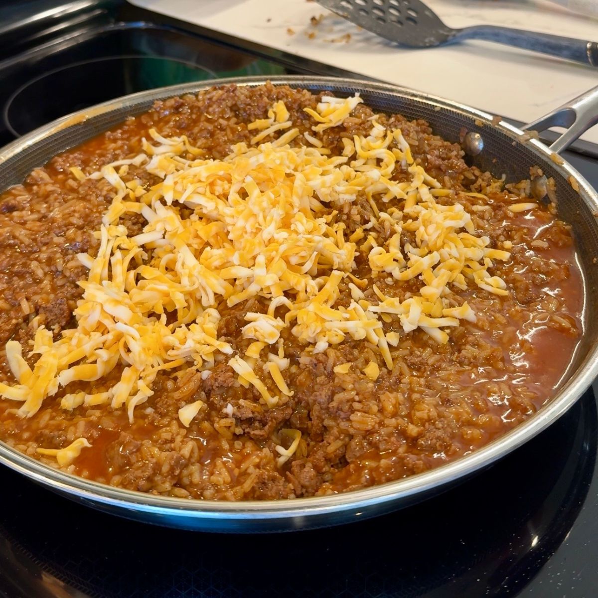 shredded colby jack cheese over ground beef and rice
