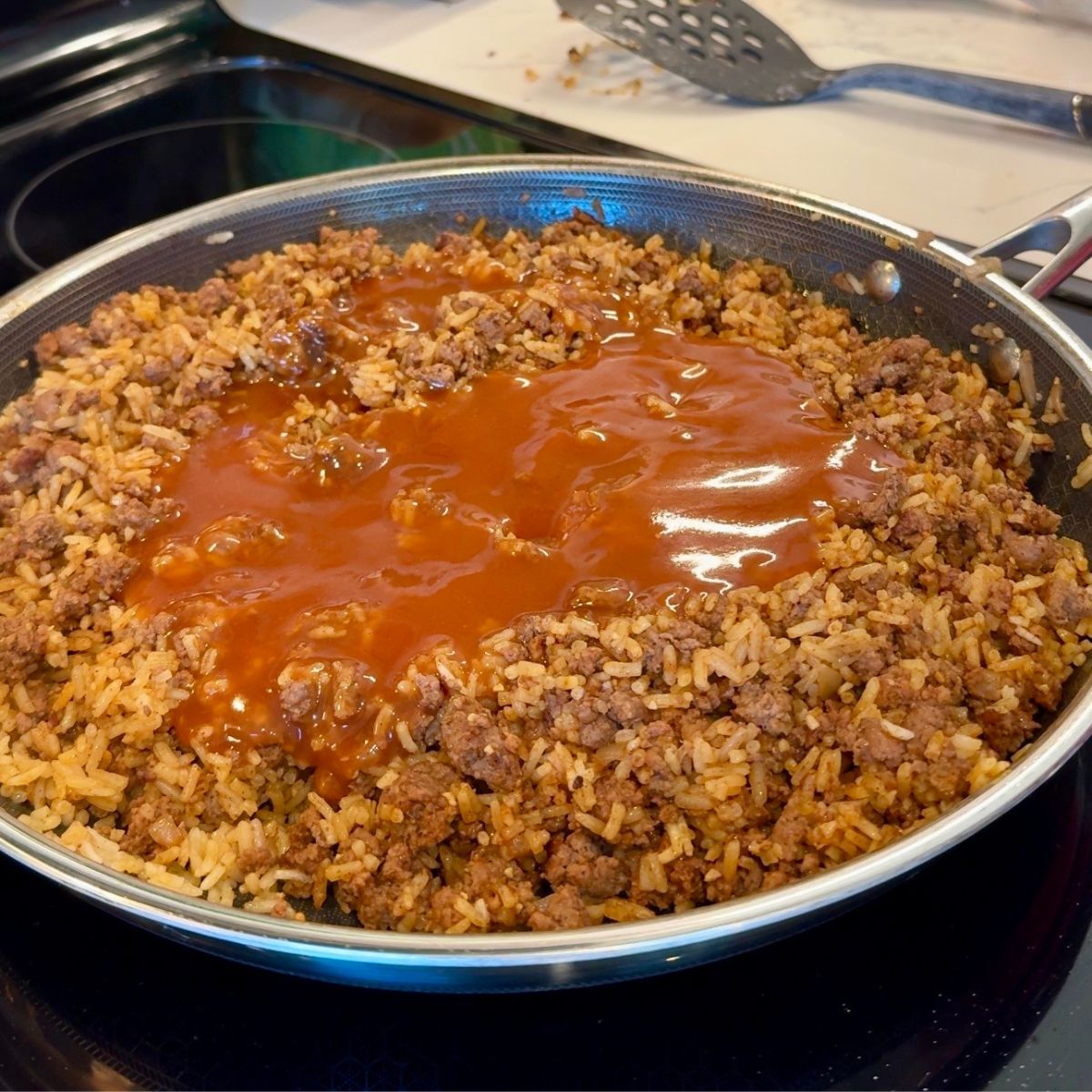 red enchilada sauce over beef and rice 