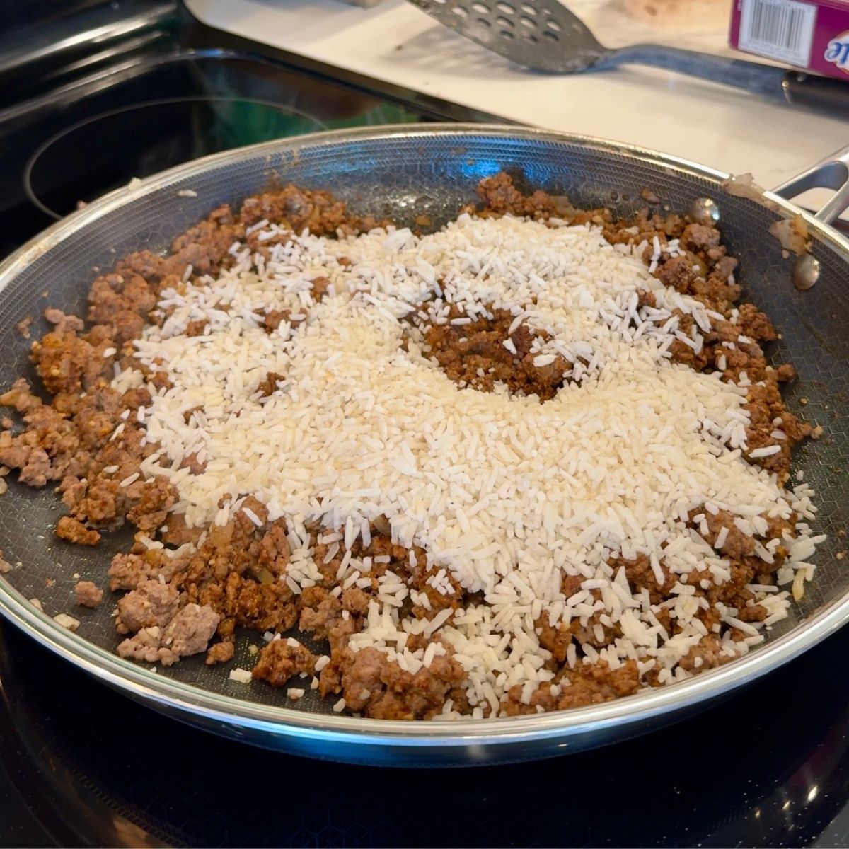 jasmine rice over beef in pan