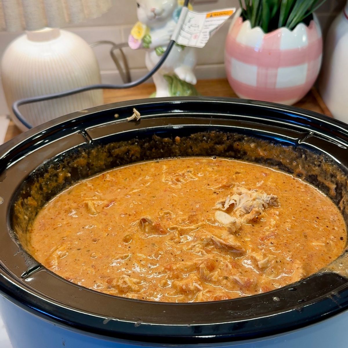 creamy pasta in slow cooker, lamp in background