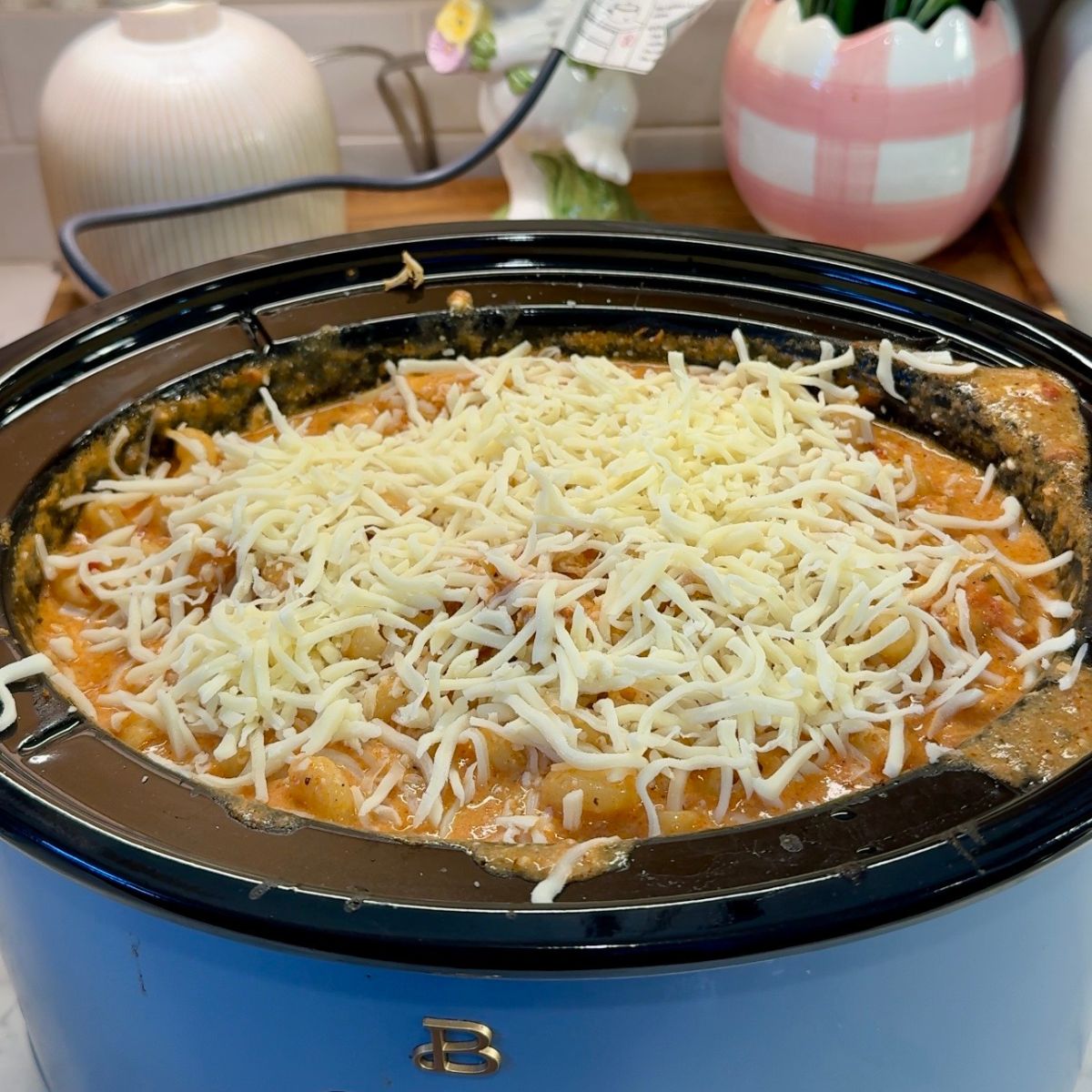 shredded mozzarella on top of chicken pasta