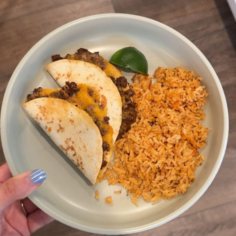 easy baked beef tacos with rice and lime wedge on green plate