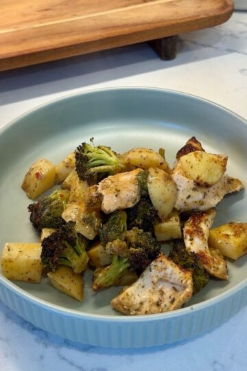 sheet pan garlic parmesan chicken with potatoes, broccoli on green plate