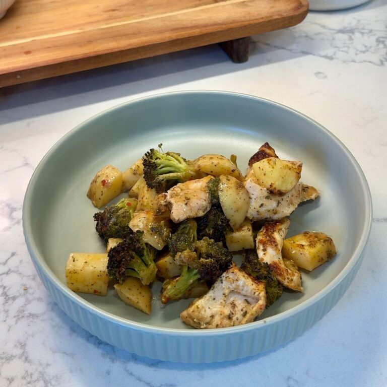 sheet pan garlic parmesan chicken with potatoes, broccoli on green plate