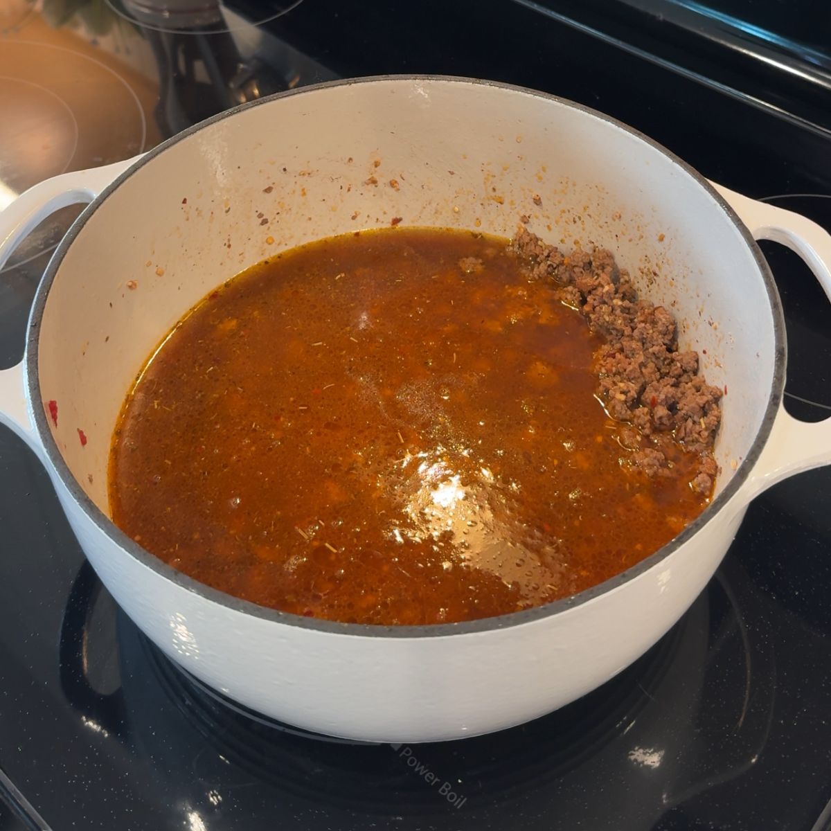 beef broth added to pot with beef