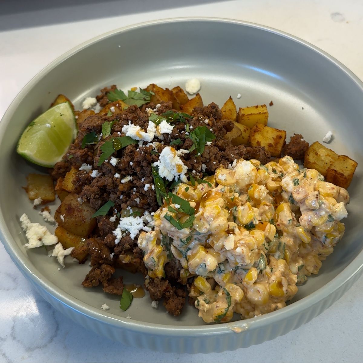hot honey streen corn potato and ground beef bowl on green plate