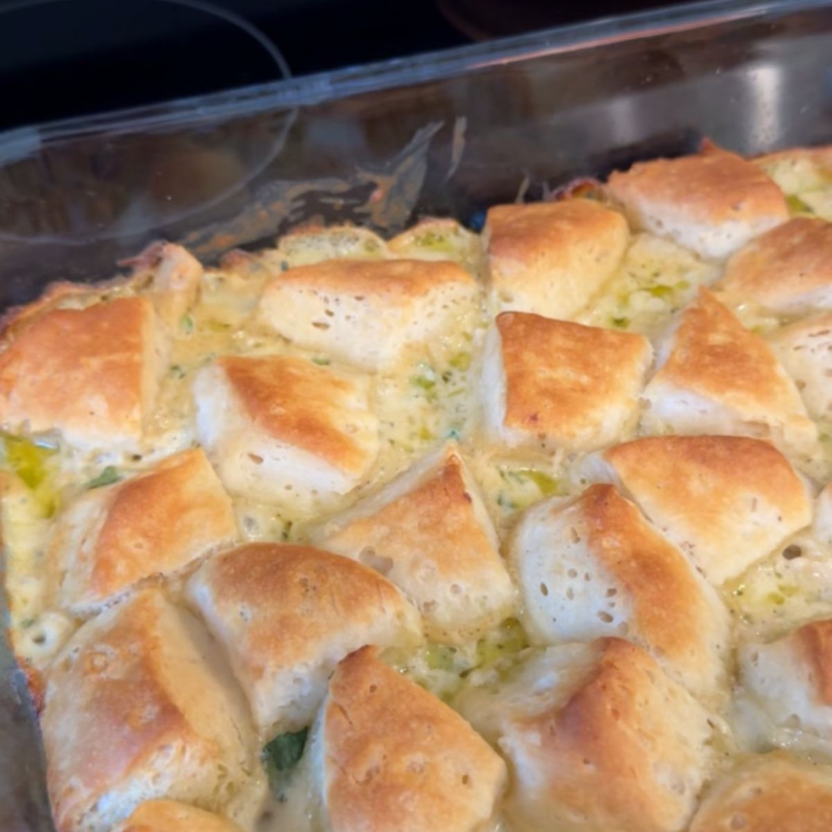 cooked chicken alfredo biscuit dough on pan