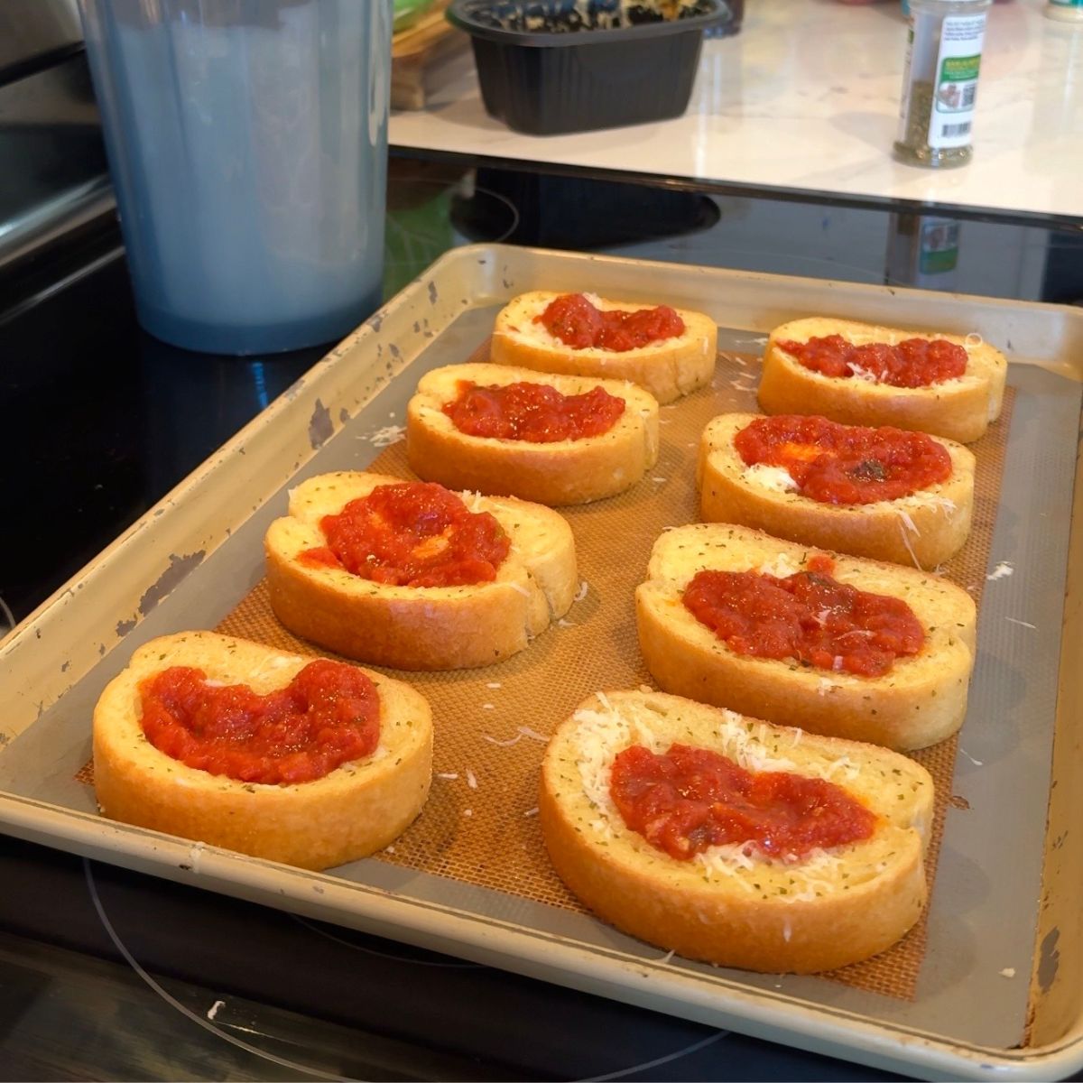marinara sauce on bread on pan