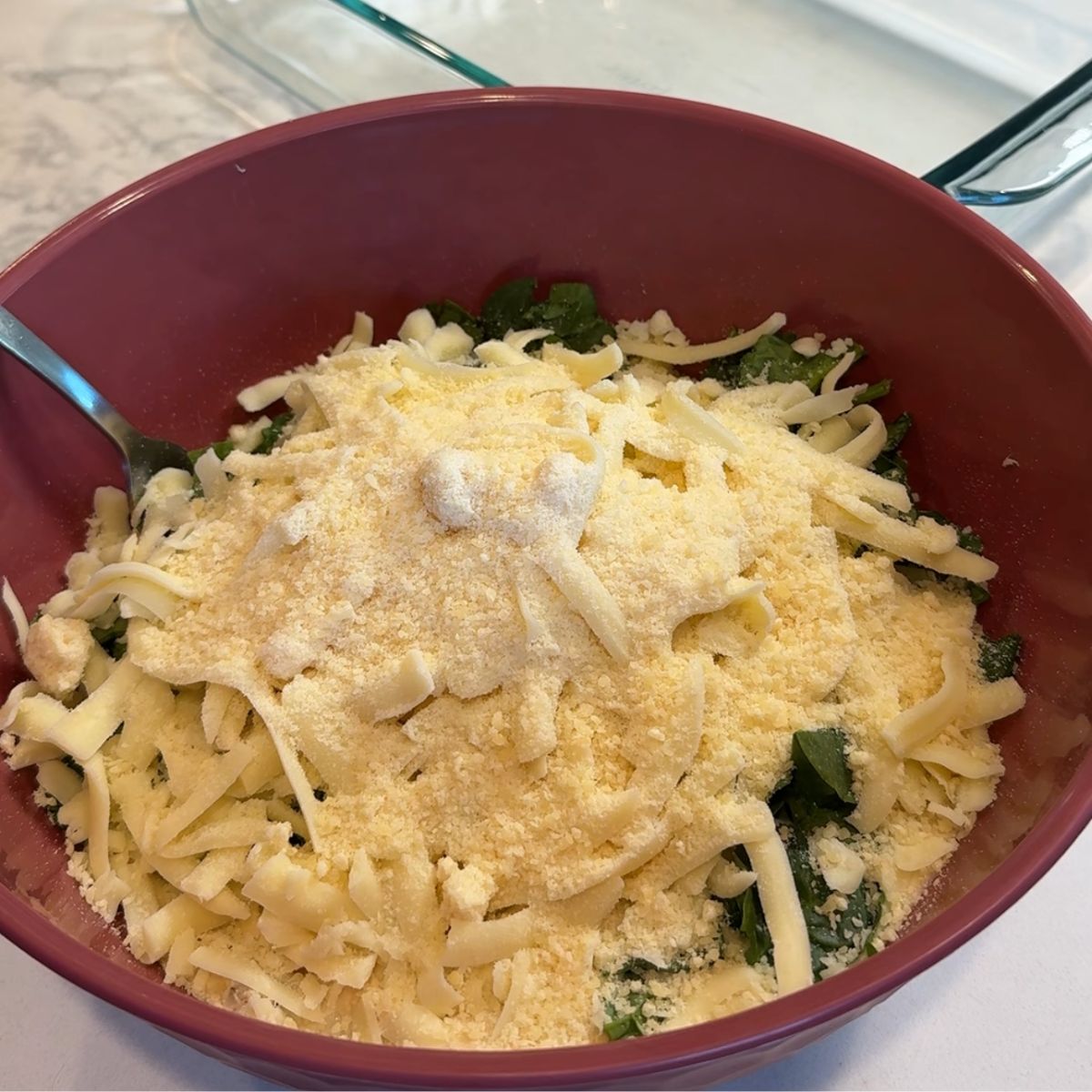 cheese added to chicken mixture in bowl