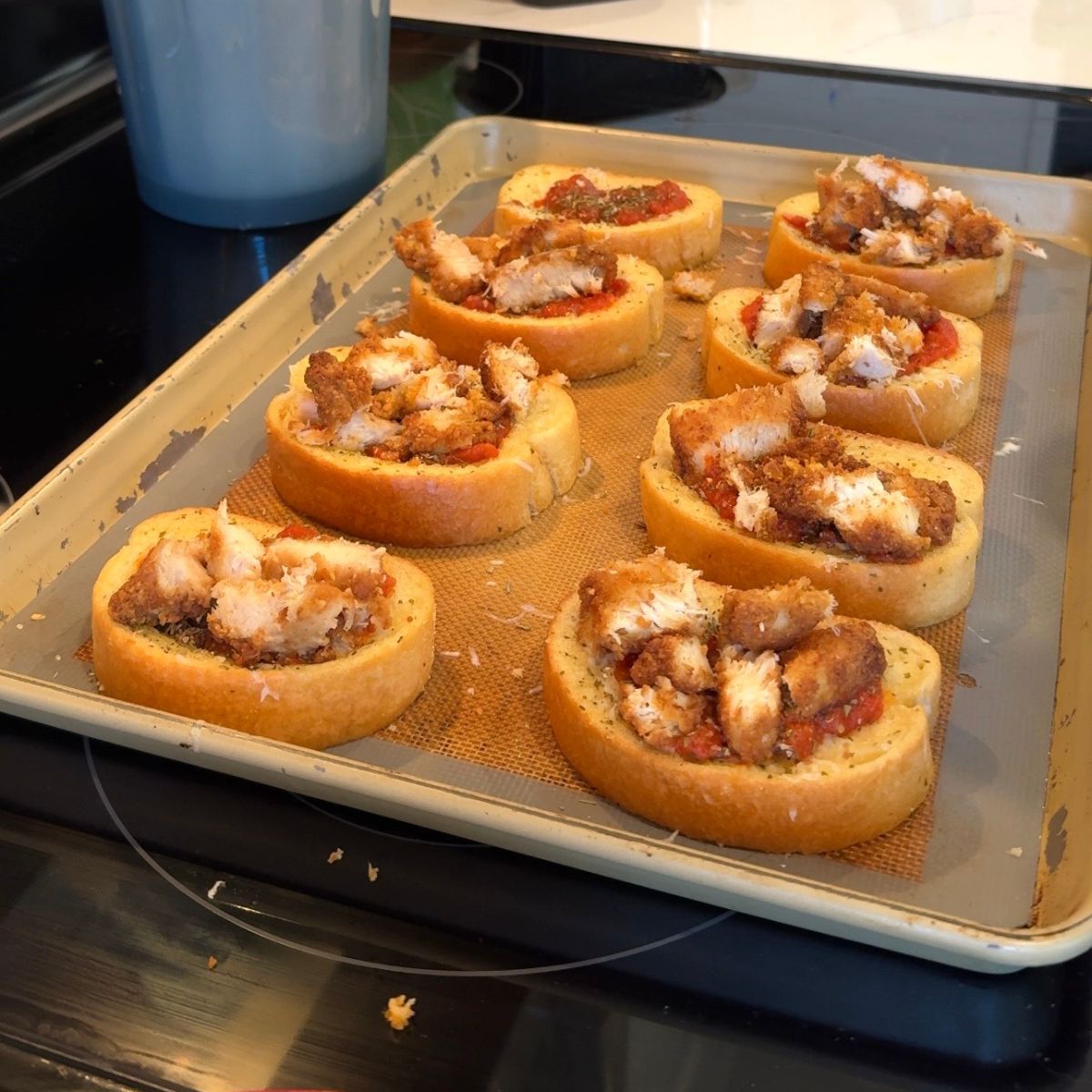 chopped chicken on red sauce on toast