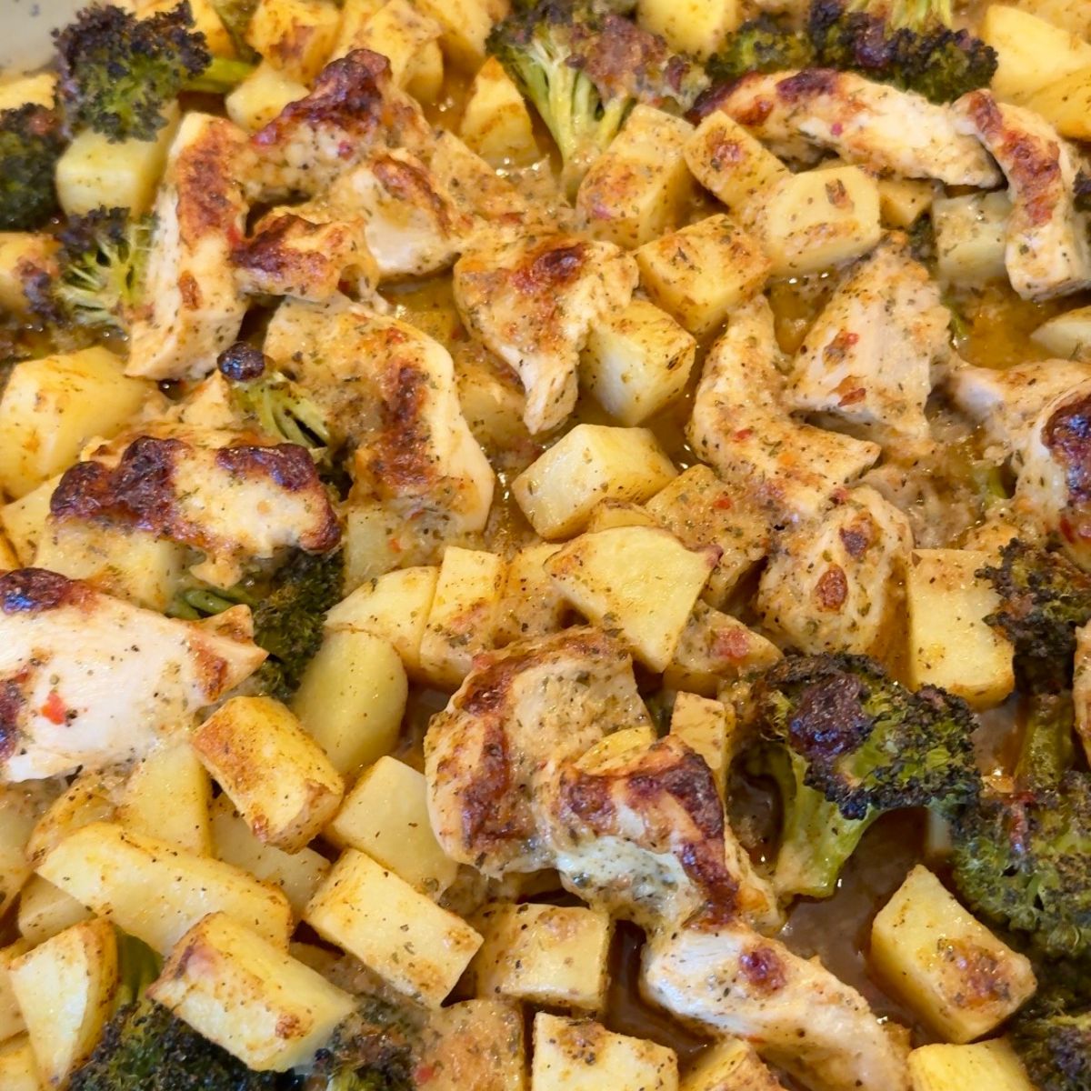 chicken on tray with potatoes and broccoli