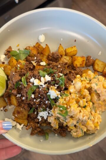 hot honey ground beef with street corn salsa, lime wedge, and potatoes