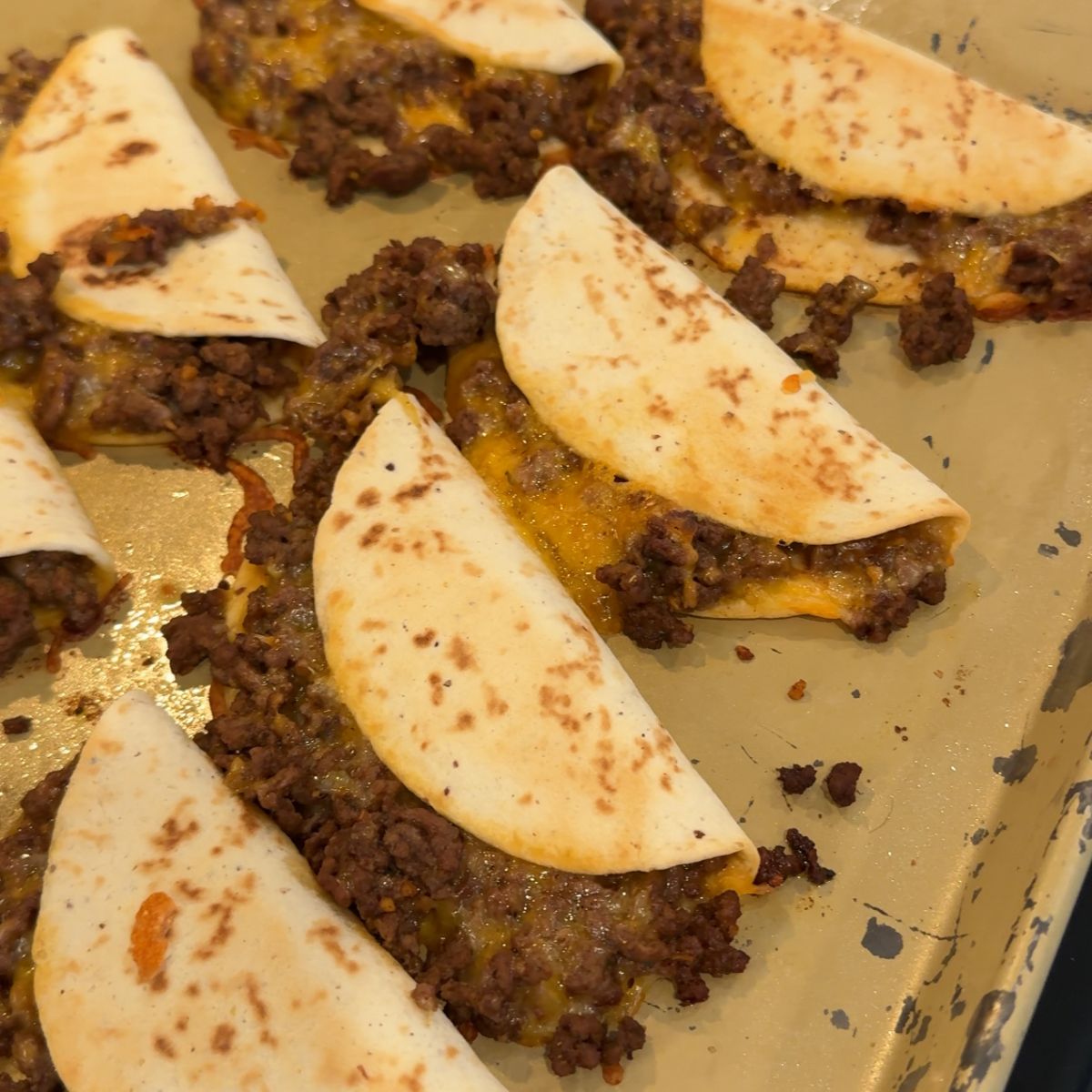 baked cheese ground beef tacos on baking tray