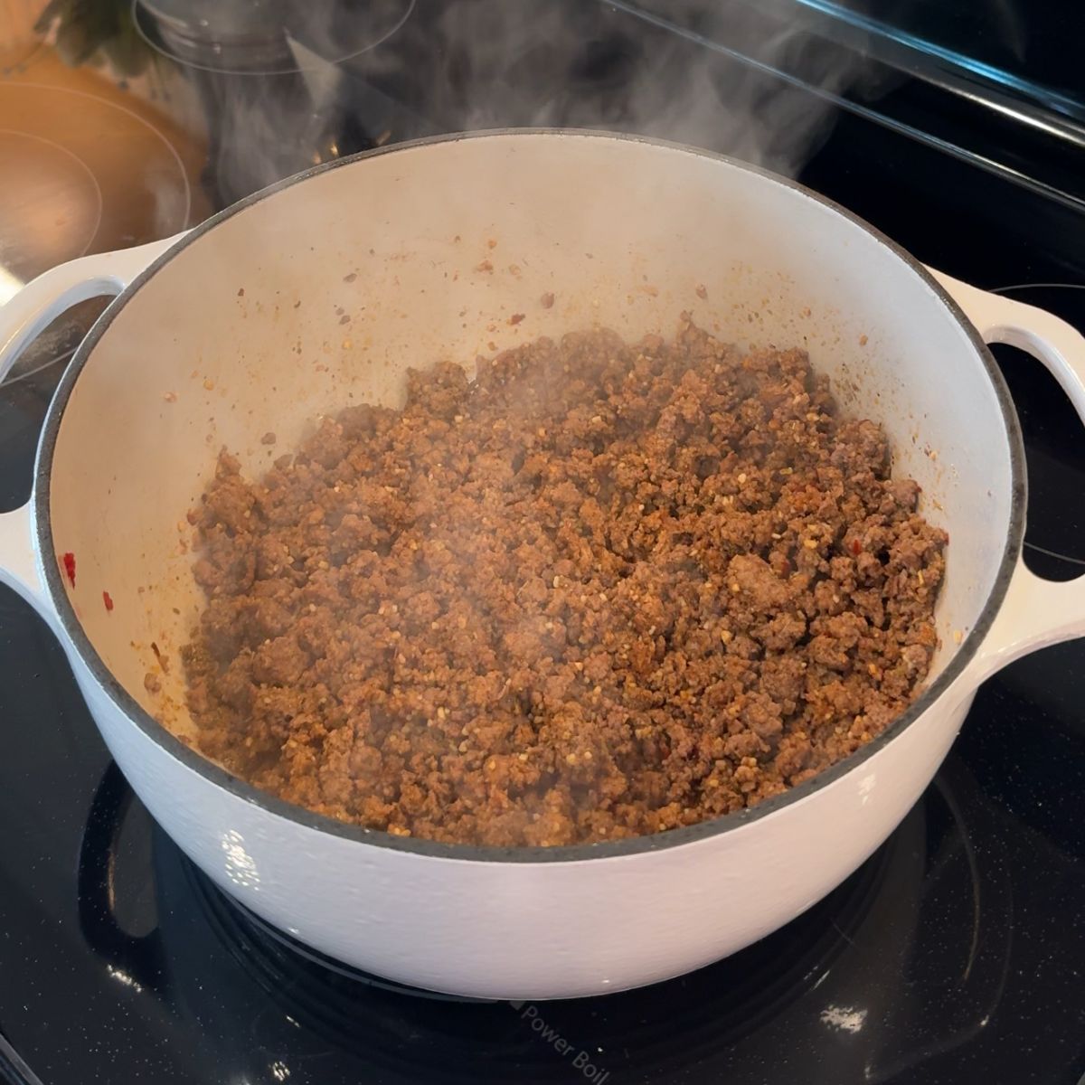 cooked beef in pot with seasonings