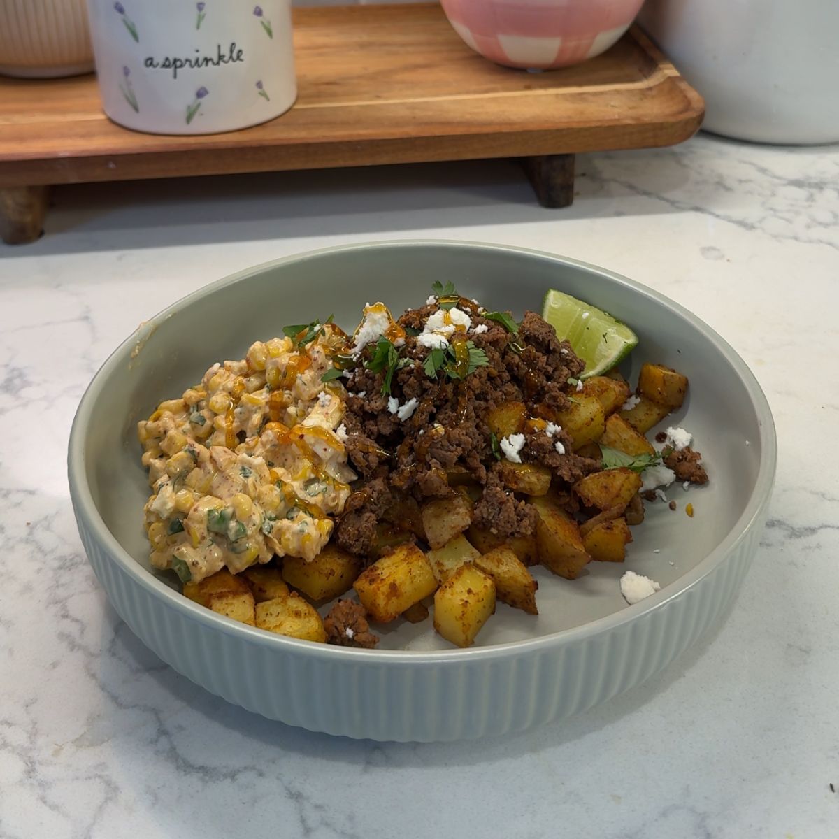 hot honey ground beef bowls with street corn salsa on green plate