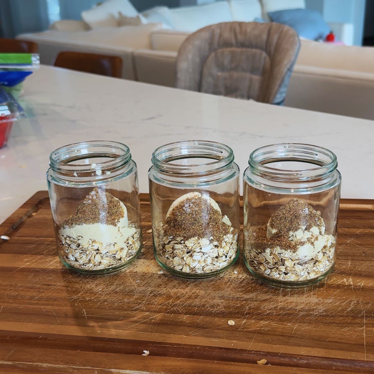 oats in 3 jars on wooden board
