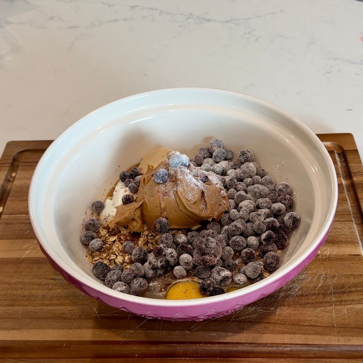 blueberries, peanut butter, and oats in mixing bowl with additional ingredients