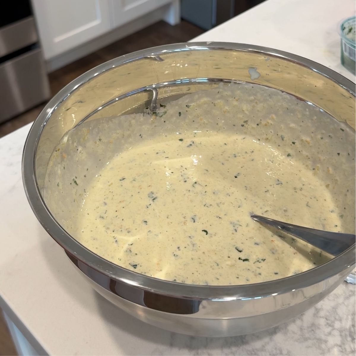 salsa verde green sauce mixture with spoon in bowl