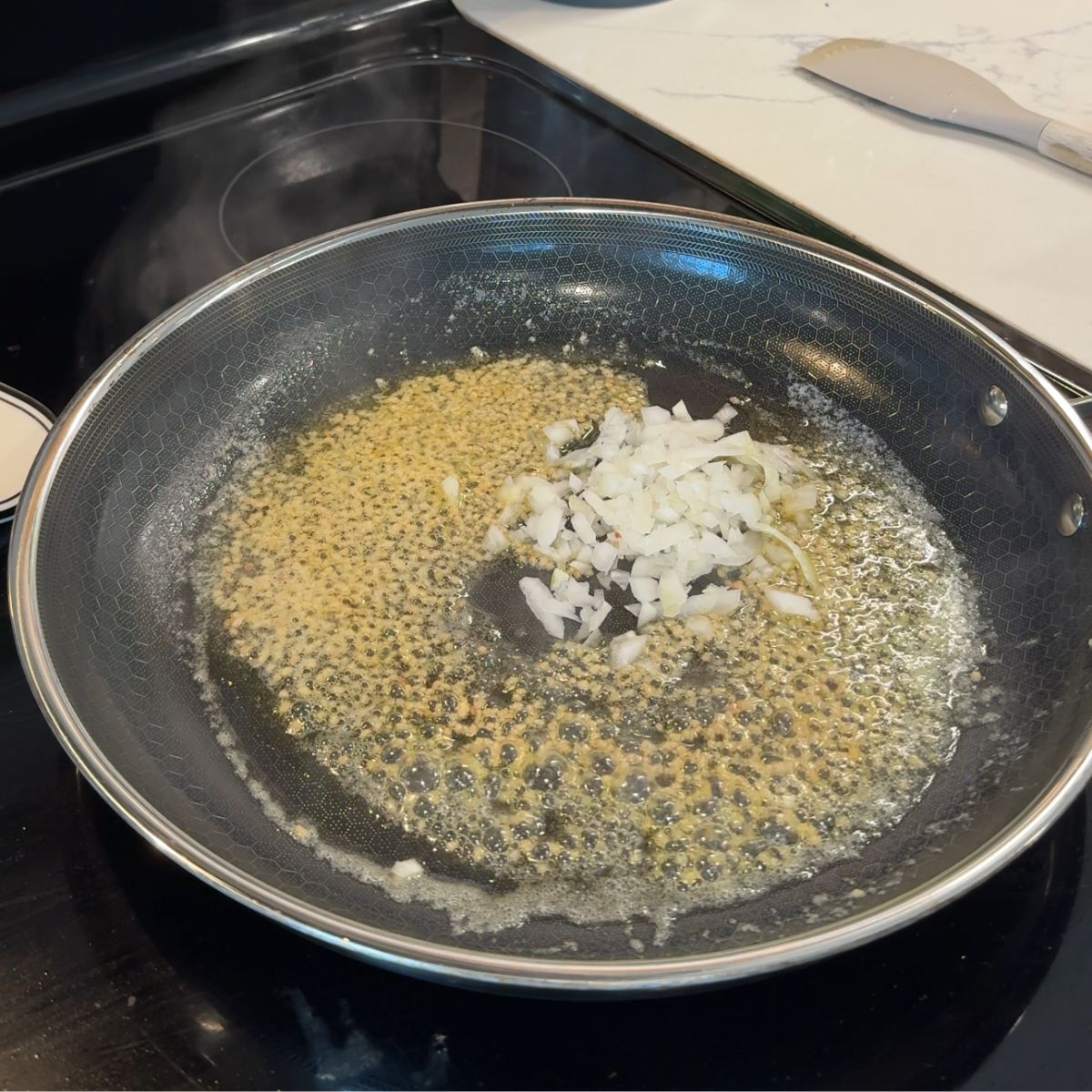 butter, garlic and onion cooking on skillet 