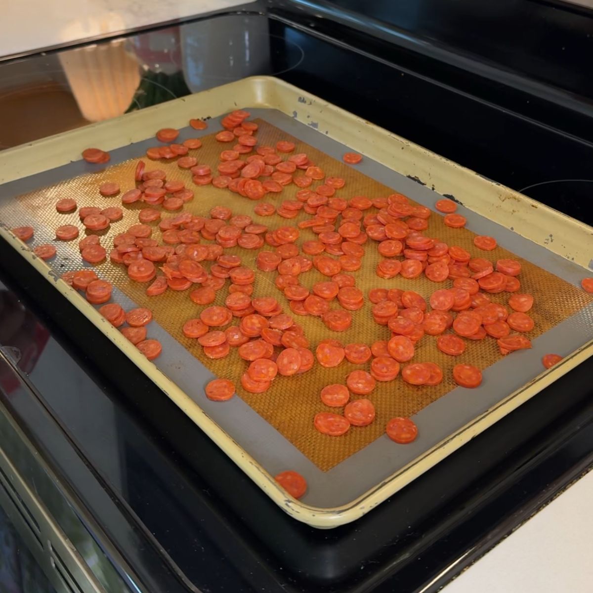 mini pepperonis on cooking tray