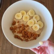 cookie butter overnight oats with biscoff cookies and banana in bowl in hand