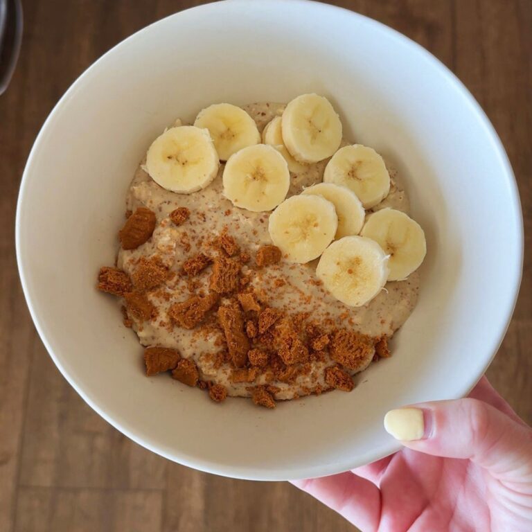 cookie butter overnight oats with biscoff cookies and banana in bowl in hand