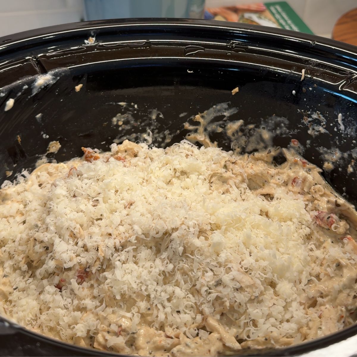 grated parmesan cheese over chicken mixture in slow cooker