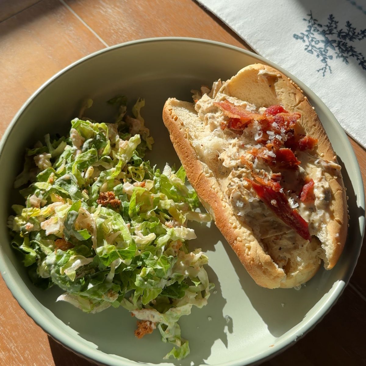 crockpot marry me chicken sandwich with salad on green plate